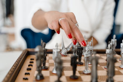 Person Playing Chess Game Close-Up Photo