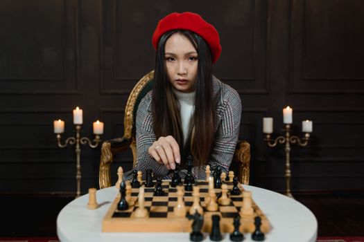 A Woman with Red Hat Playing Chess