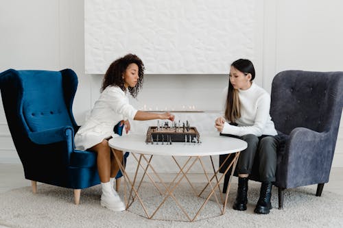 Free Women Playing a Board Game of Chess Stock Photo