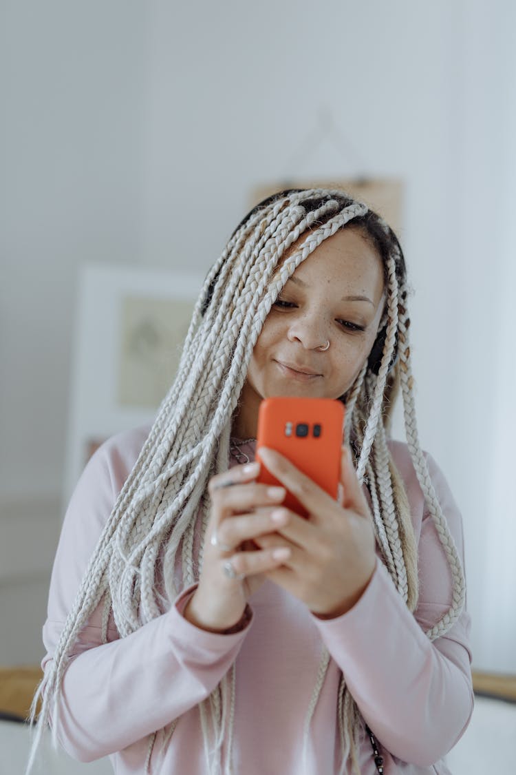 Woman With Braided Hair Holding Cellphone