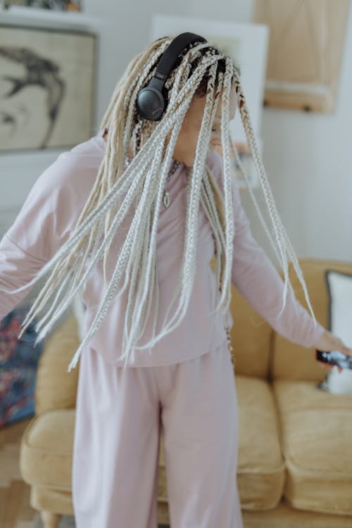 Free Carefree Woman with Afro Braids wearing Pink Loungewear  Stock Photo