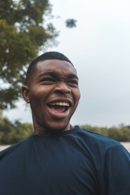 Smiling Man in Blue Crew Neck Shirt