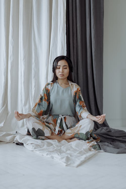 A Woman Meditating in a Room