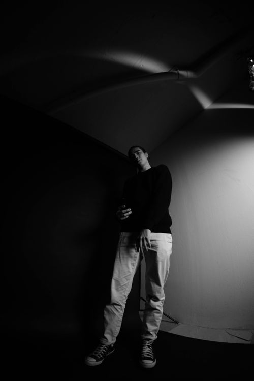 Free Black and white of young full body male in contemporary spacious photo studio Stock Photo