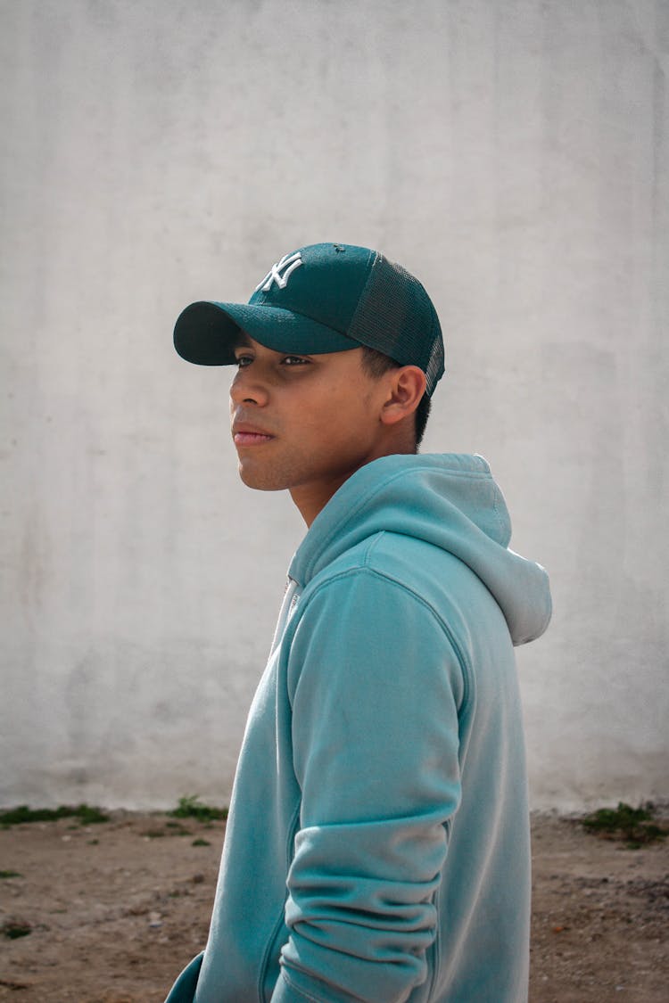 Boy In Blue Baseball Cap And Blue Hoodie