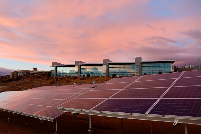 BIPV Solar Facade on a Modern Commercial Building Solar energy panels near a modern commercial building at sunset demonstrating BIPV facade integration