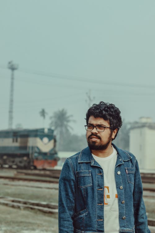 Free A Man Standing Near the Railway Stock Photo