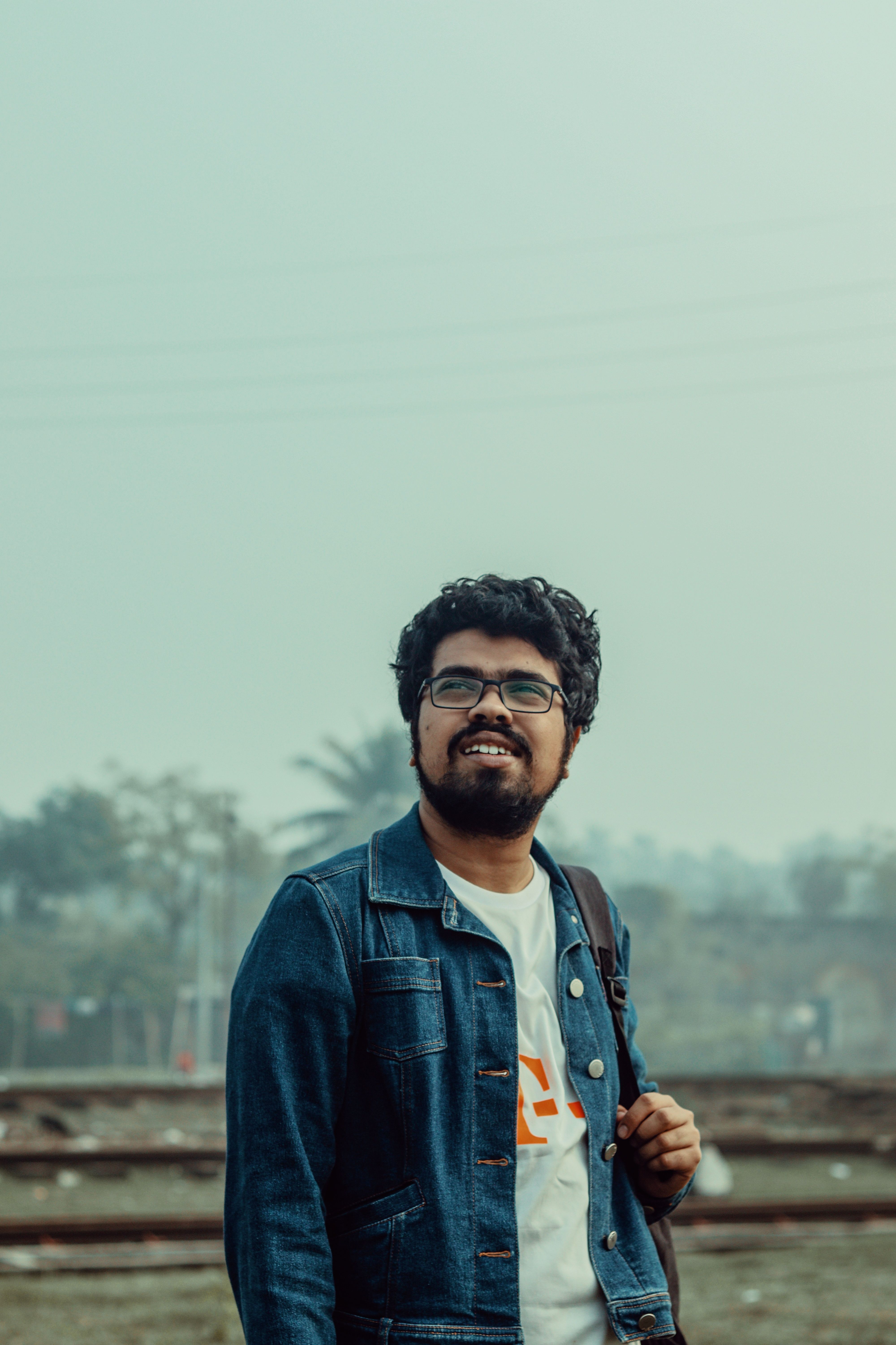 Portrait of a man with a beard smiling outdoors in Khulna, Bangladesh.