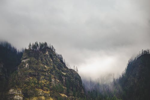 Foggy sky over rocky mountainous valley