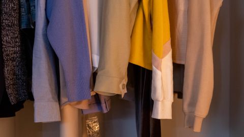 A stylish collection of clothes and shoes neatly arranged in a closet.