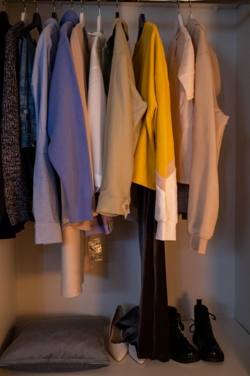 Free A stylish collection of clothes and shoes neatly arranged in a closet. Stock Photo