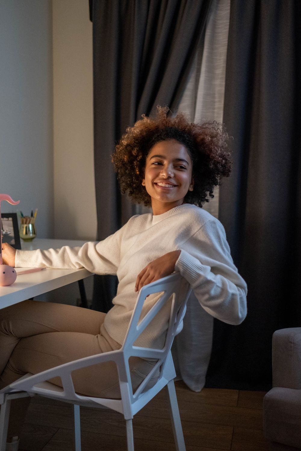 A Woman in White Sweater Sitting on White Chair · Free Stock Photo