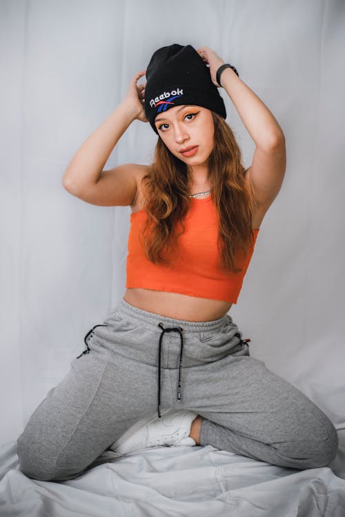 A Young Woman in Orange Crop top and Beanie Hat