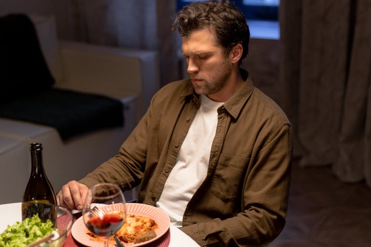 A Man Unbuttoned Long Sleeves  Eating Dinner 