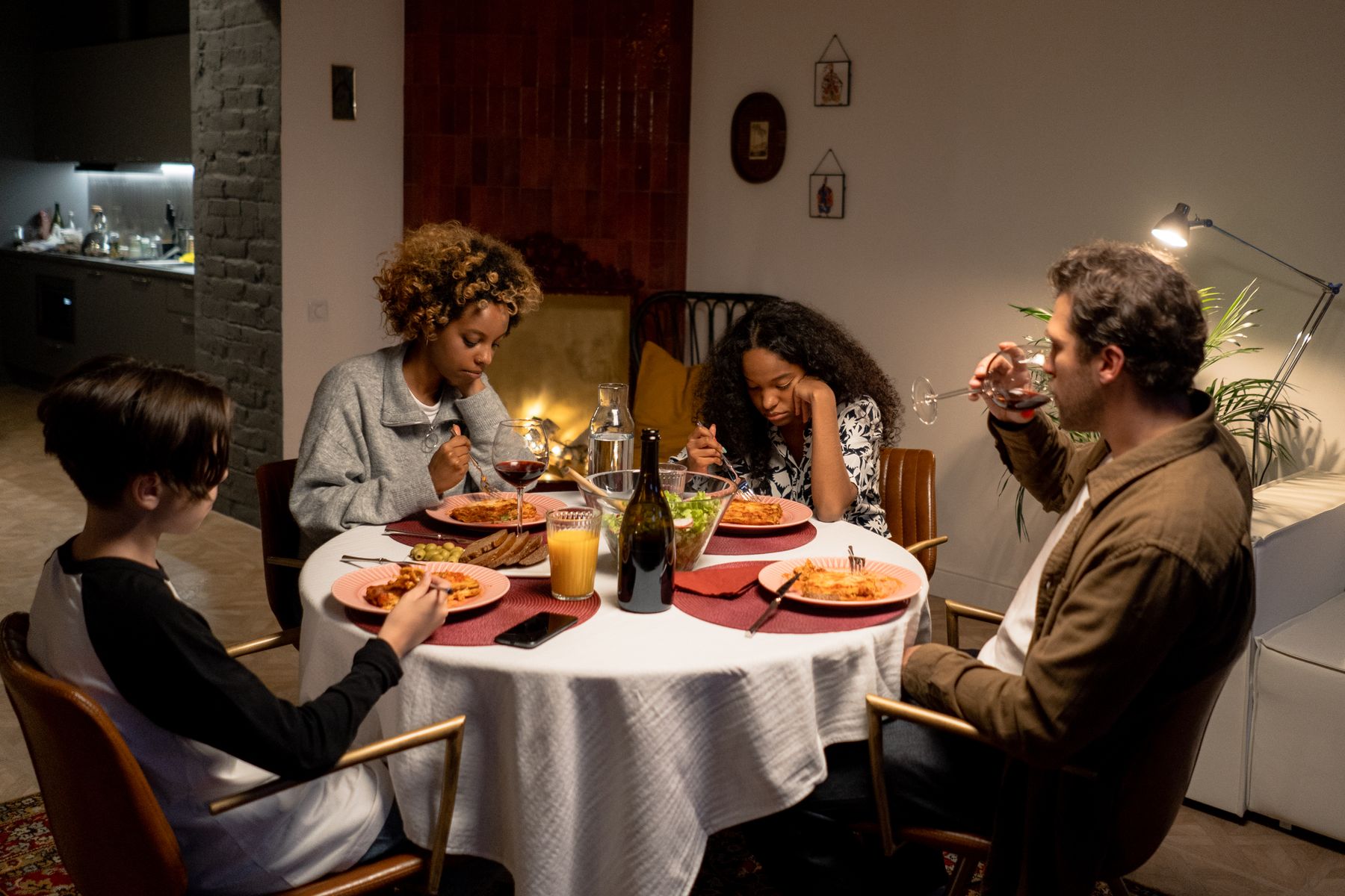 Still from The Fairweathers: the family around a crowded dinner table. Photo by cottonbro studio on Pexels