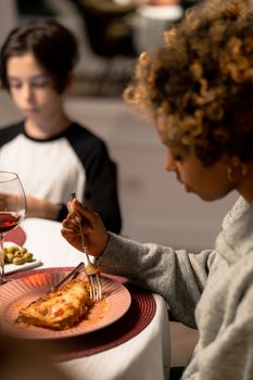 A cozy family dinner scene with lasagna and wine, highlighting shared moments.