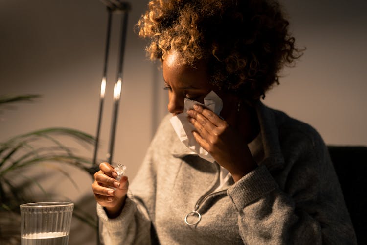 A Woman Wiping Her Tears With Tissue