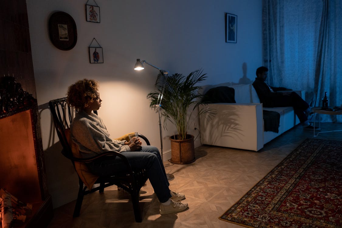 couple sitting in different areas of the living room