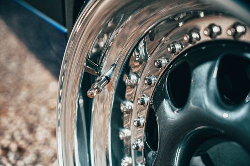 Free Closeup of shiny steel disc of wheel of blue car parked on ground in daytime Stock Photo