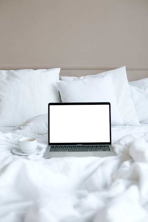 Free A Laptop on the Bed Stock Photo
