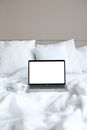 Macbook Pro on White Bed