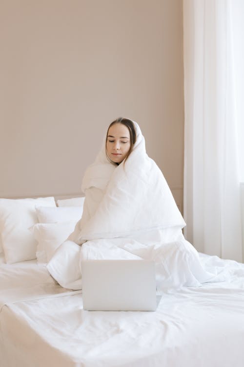 A Woman Wrapped with White Blanket