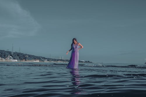 Free Woman walking in water near coast Stock Photo
