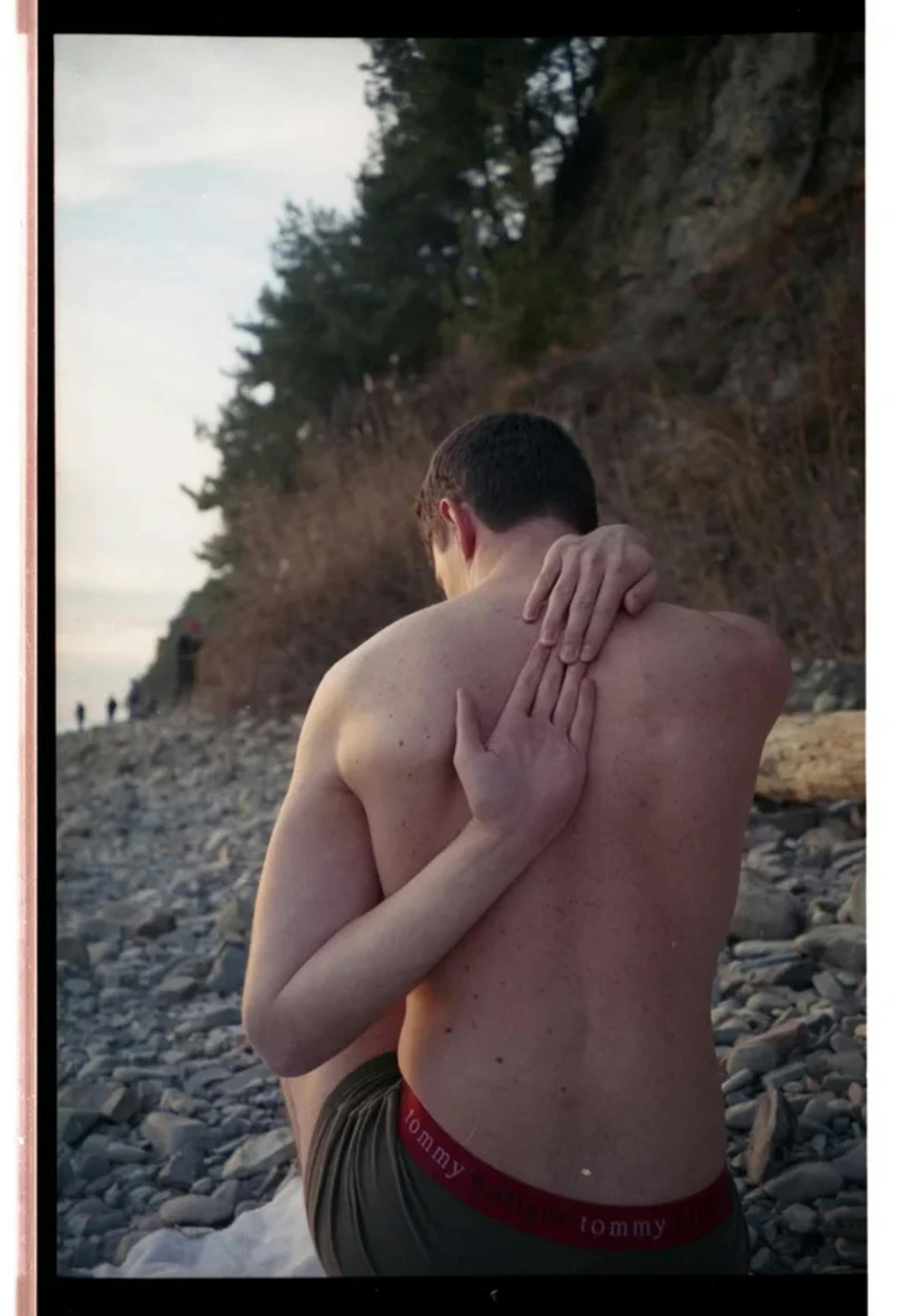 Topless Man Covering His Face With His Hand
