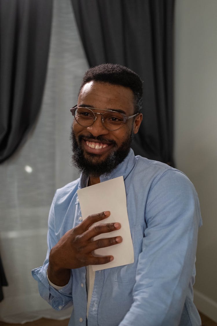 A Happy Man Holding A Picture