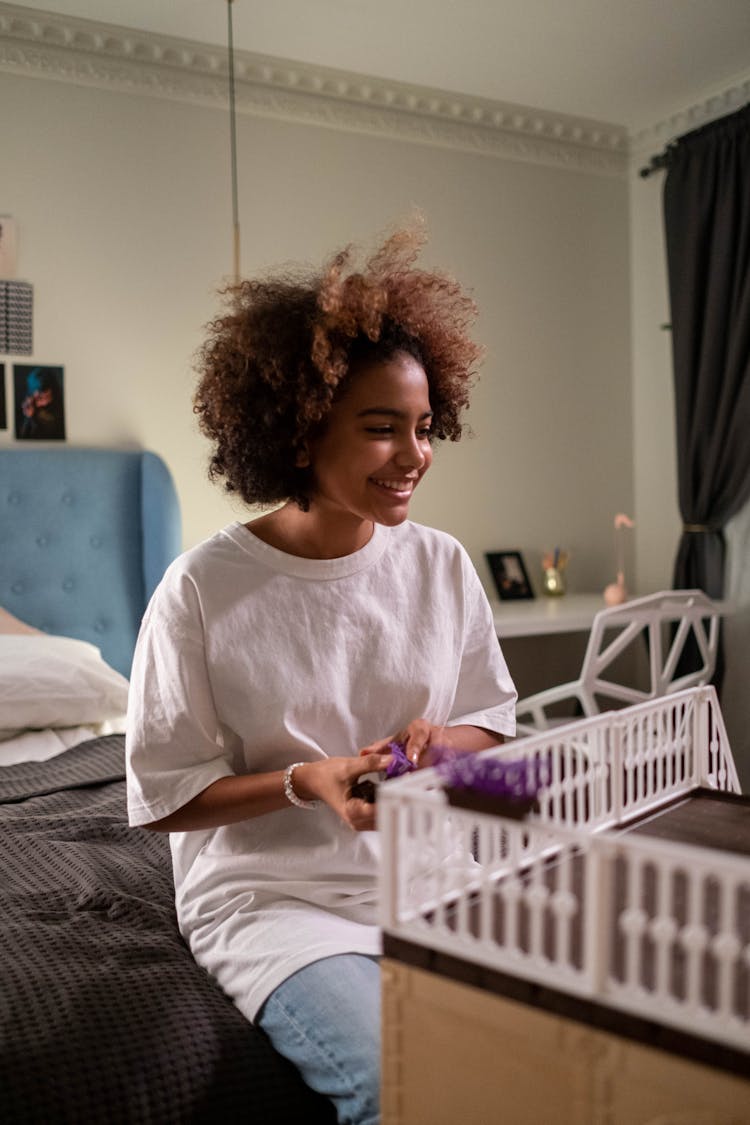 A Girl Playing The Dollhouse