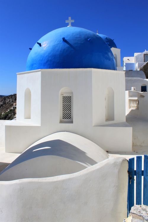 Free Capture the beauty of Santorini's iconic blue domes against a vivid summer sky, embodying Greek charm. Stock Photo