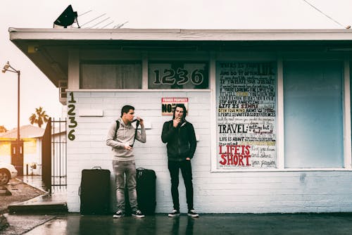 Men with Luggage Resting Under a Roof