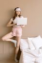 A Woman Standing in One Feet Using a Laptop