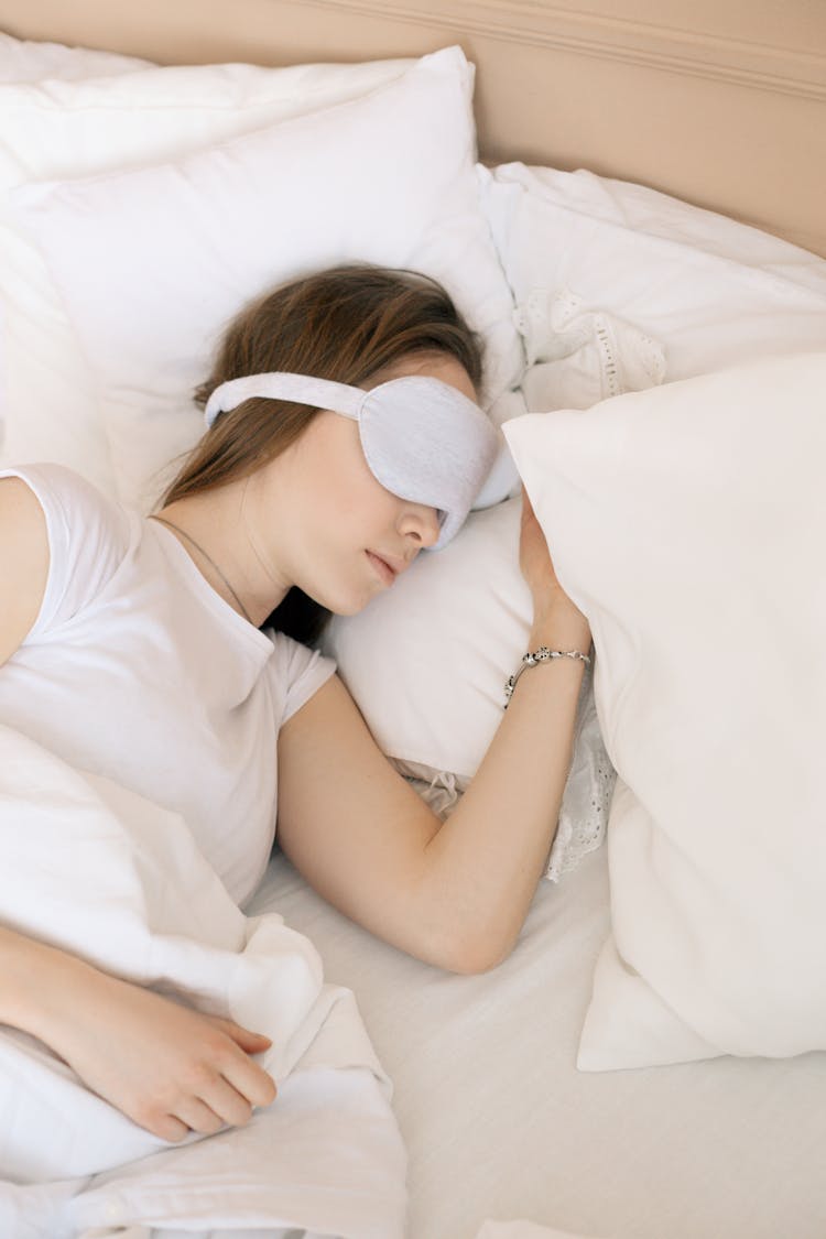 A Woman Sleeping With A Sleep Mask