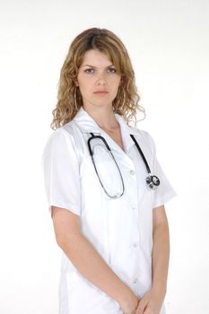 Portrait of a young nurse in white standing confidently with a stethoscope around her neck.