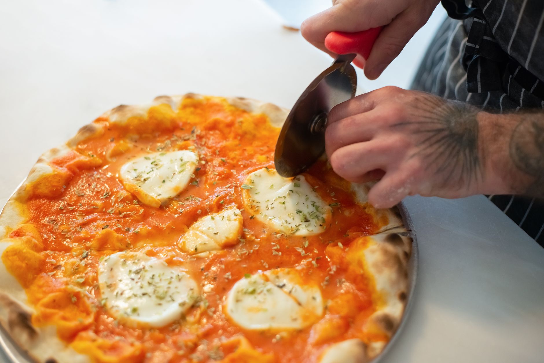 Slicing a homemade pizza slicing homemade pizza