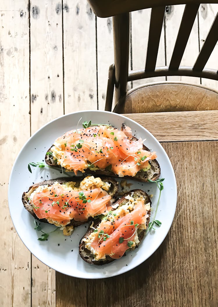 Delicious Breakfast With Fish Sandwiches On Plate