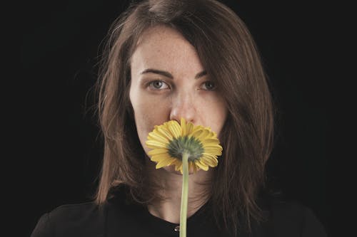 Darmowe zdjęcie z galerii z czarne tło, kobieta, kwiat