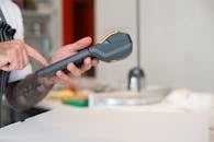 A Person Holding a Black Calculator