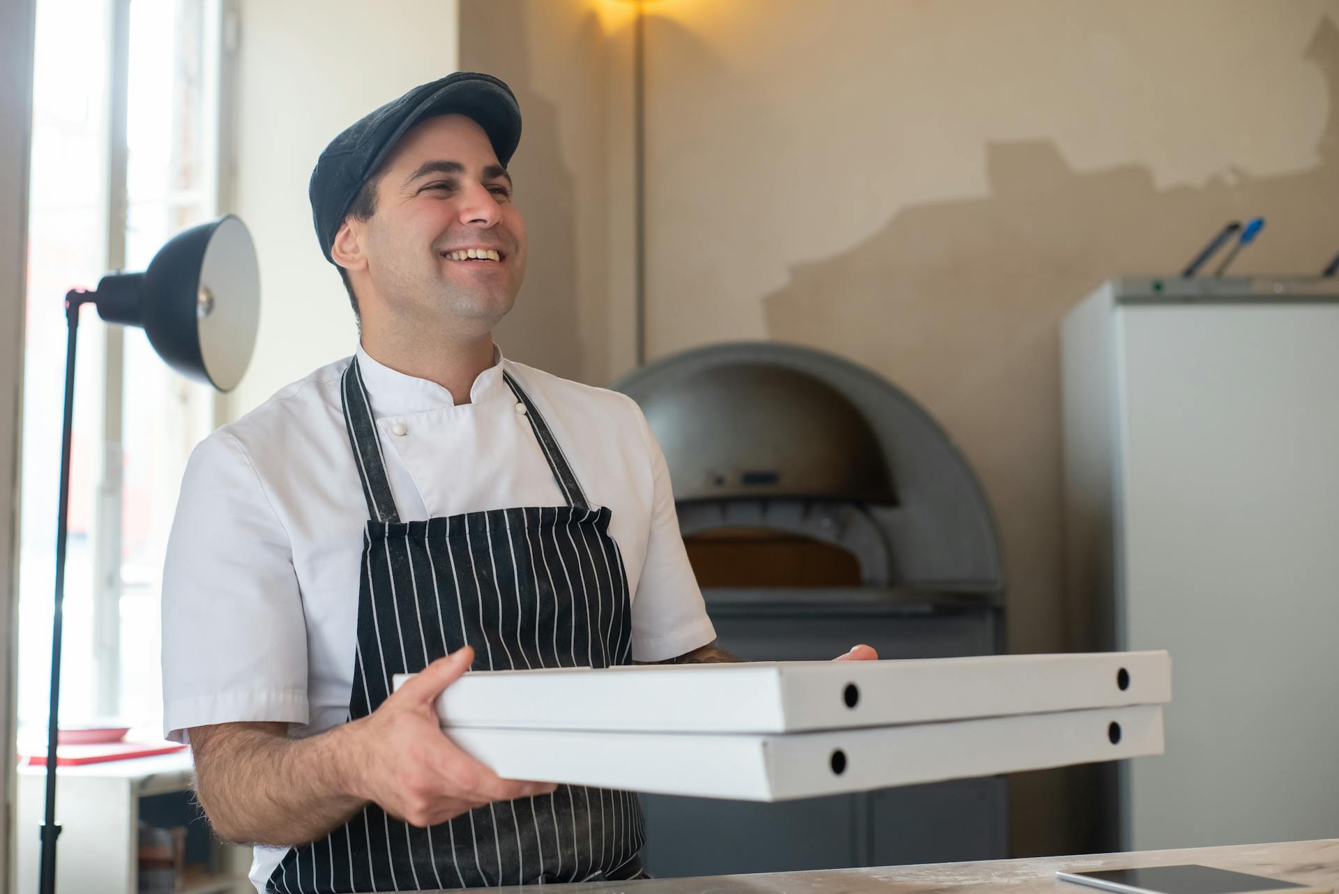 A Chef Carrying Pizza Boxes