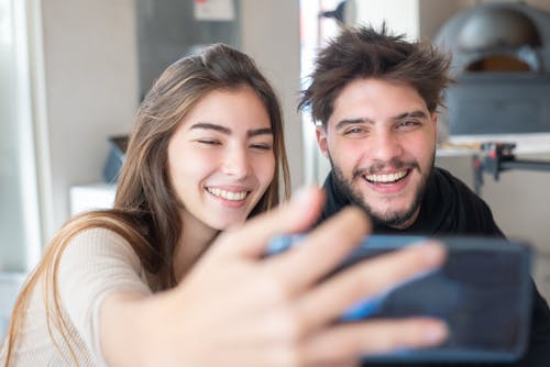 A Woman and a Man Taking a Selfie