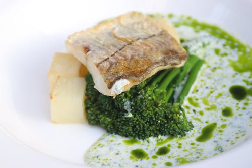 Delicious fish with broccoli on plate