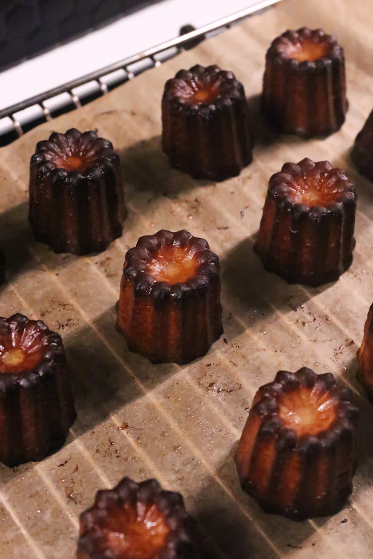 Sweet Caneles On Baking Paper