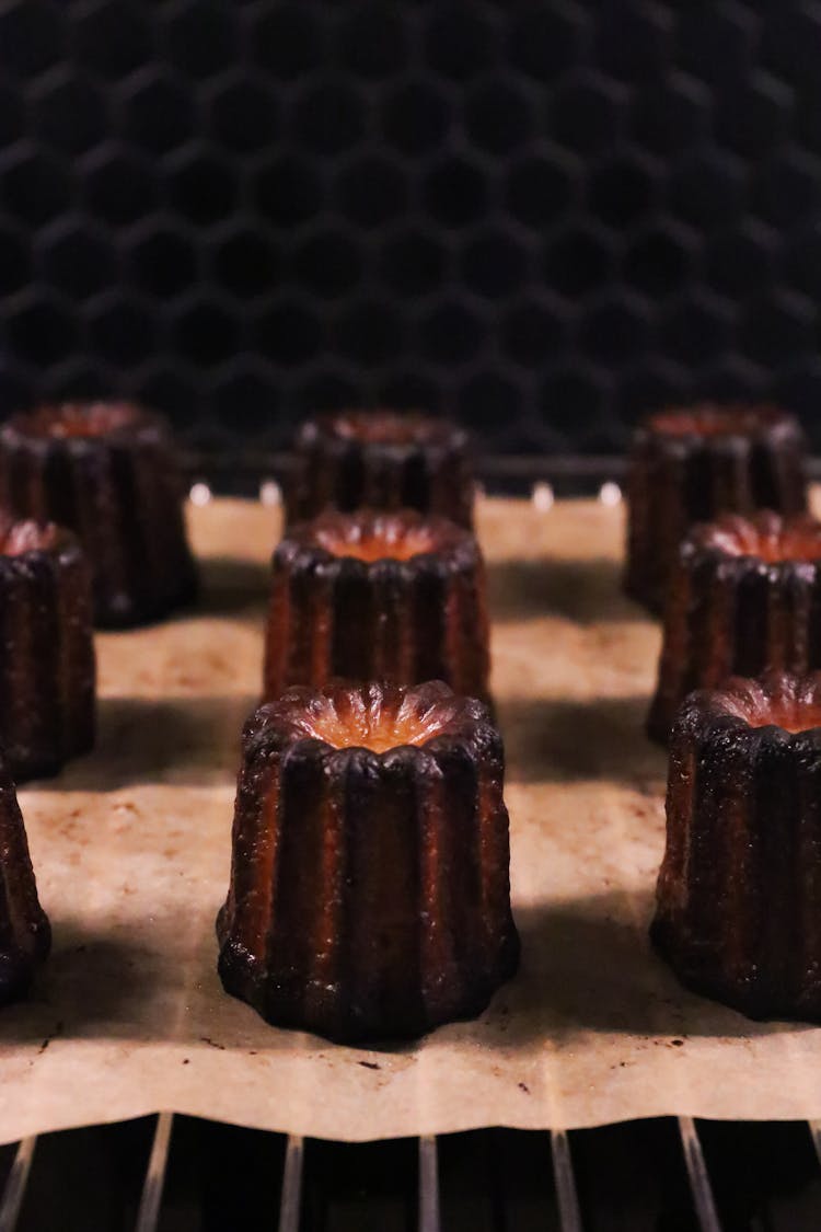 Various Caneles On Metal Rack