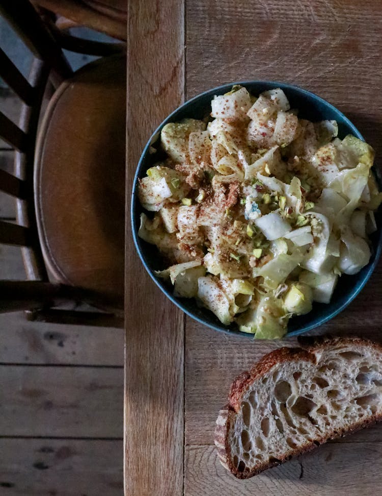 Green Salad With Bread On Table