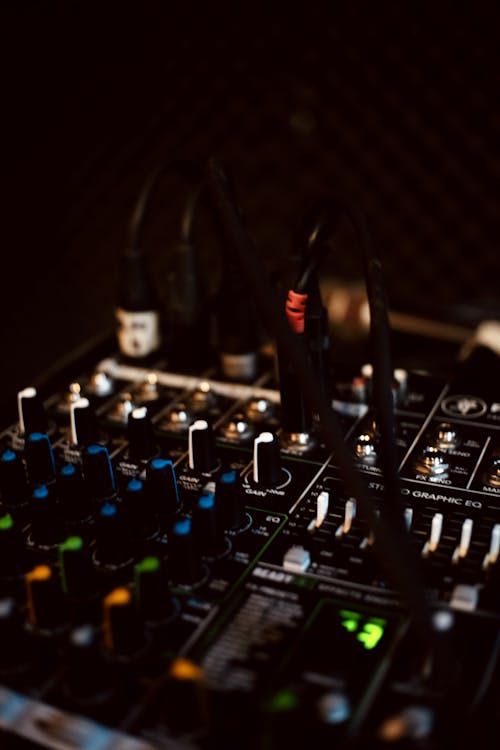 An Audio Mixer with Multi Colored Knobs in Close-up Photography