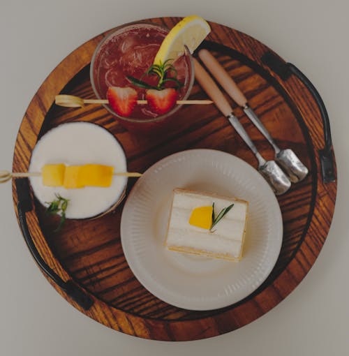 A Delicious Meal with Fruits and a Glass of Strawberry Juice on a Wooden Tray