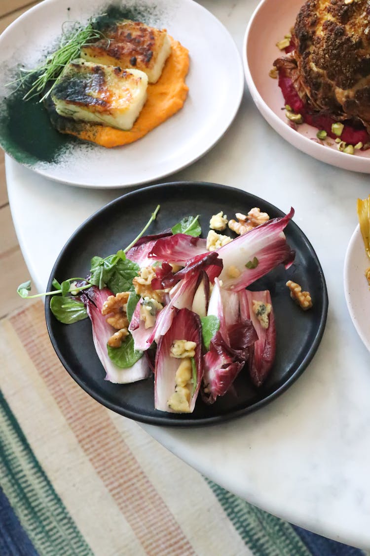 Places With Delicious Fresh Salad And Fish Served On Table In Restaurant