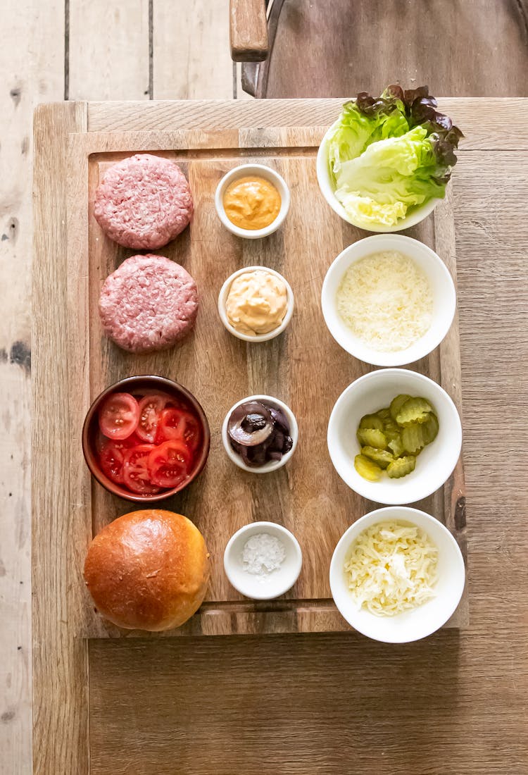 Ingredients For Burger Placed On Wooden Table