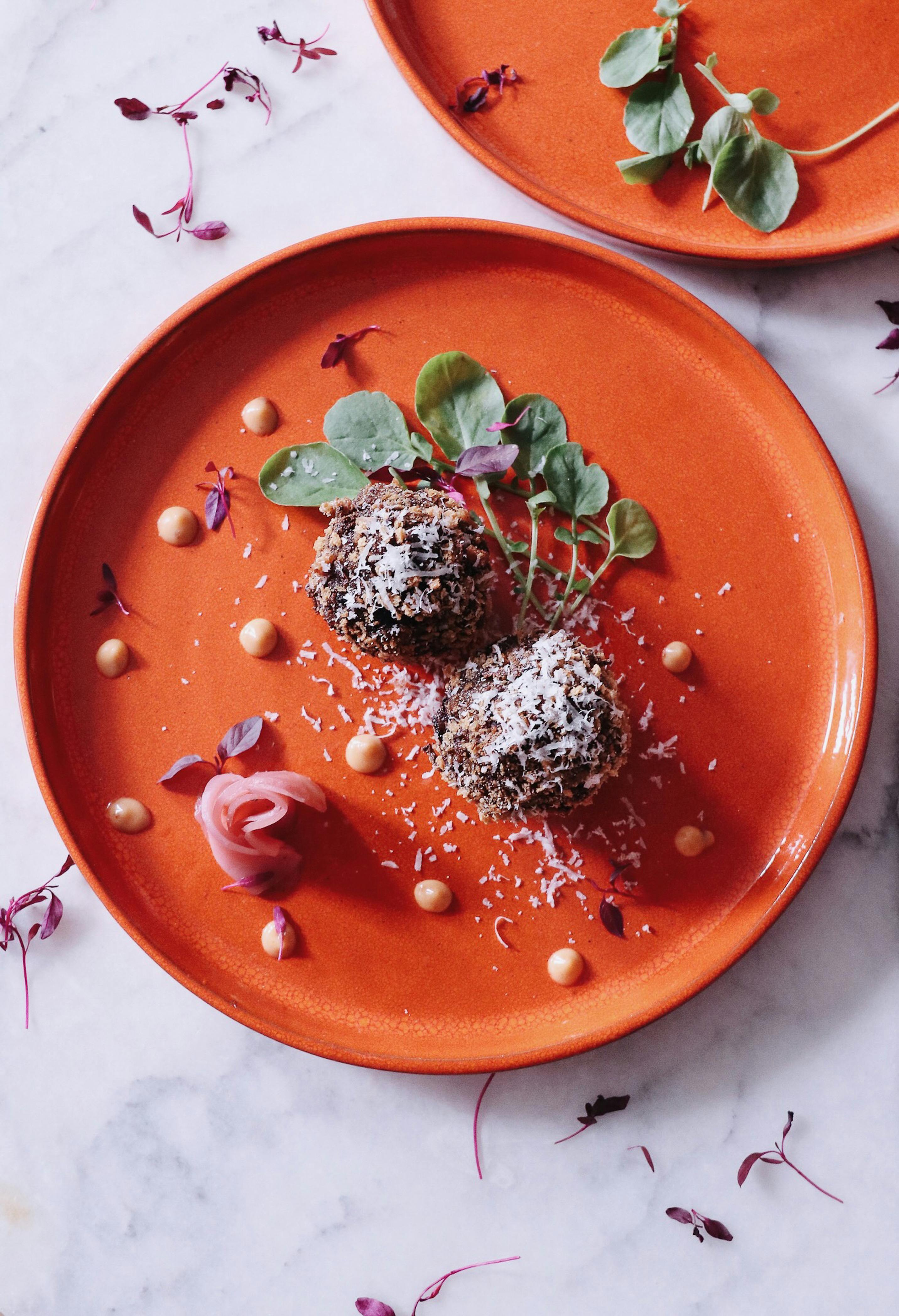 dessert with coconut flakes on plate with herbs